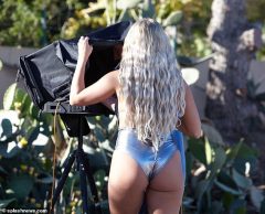 Amber Turner flaunts her sensational curves in a skimpy silver swimsuit