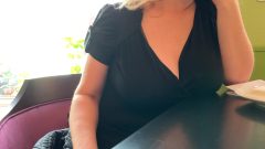 hot blonde woman flashing big tit in a public cafe
