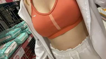 Teen of perfect tits with sports bra in a store