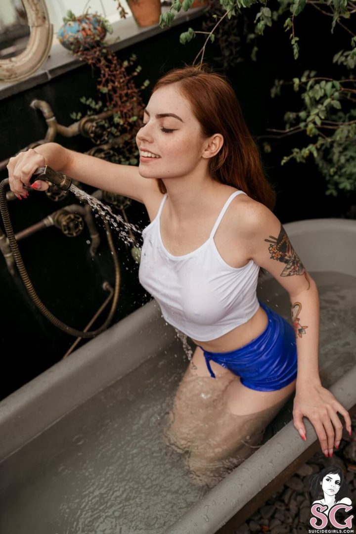 sexy girl getting wet with braless top