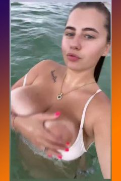 wet babe with big boobs with large areolas in the sea