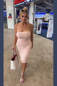 big busty woman braless in tight dress in the mall