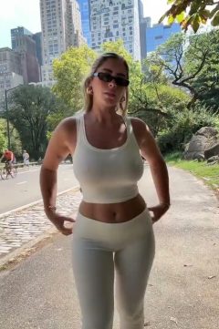 sexy hot babe with big tits wearing a braless tank top and yoga pants