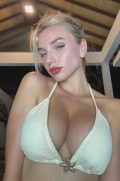 Gorgeous blonde woman with hot red lips untying her bikini top to reveal and bounce her natural breasts in a close-up video.