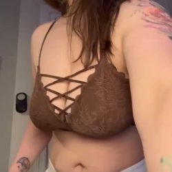 Seductive vamp amateur woman at home dropping her big natural boobs out of a tight crop top, high-quality NSFW home reveal.