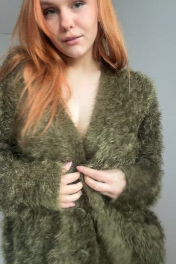 Freckled busty redhead opens her jacket