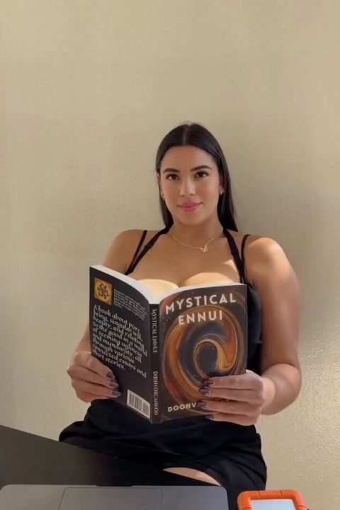 beautiful amateur girl with big boobs reading a book