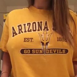 Attractive Arizona girl performing a titty drop from a sports jersey, revealing her big natural breasts in a high-quality amateur NSFW reel.