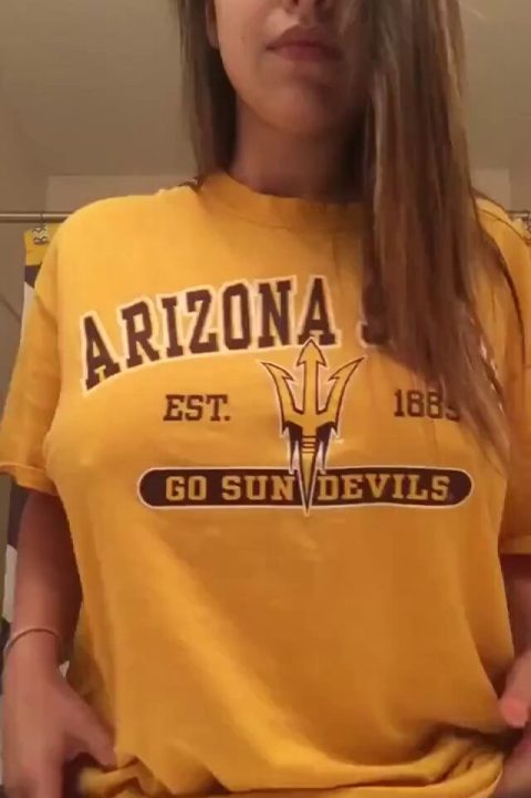 Attractive Arizona girl performing a titty drop from a sports jersey, revealing her big natural breasts in a high-quality amateur NSFW reel.