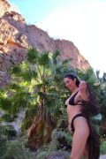 Sexy fit girlfriend on vacation outdoors, pulling down her black swimsuit to reveal her big natural tits in a high-quality NSFW short clip.