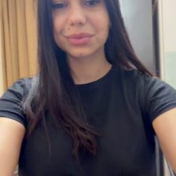 Sexy young amateur brunette smiling as she takes the viral on/off challenge, transitioning from a tight black outfit to completely naked.
