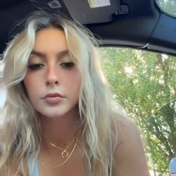 Stunning blonde independent creator posing outside a vehicle on a secluded roadside, captured through the passenger window as she sheds her outfit to go completely naked.- prview