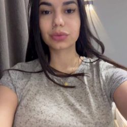 Sexy busty woman getting naked in the mirror - short video frame