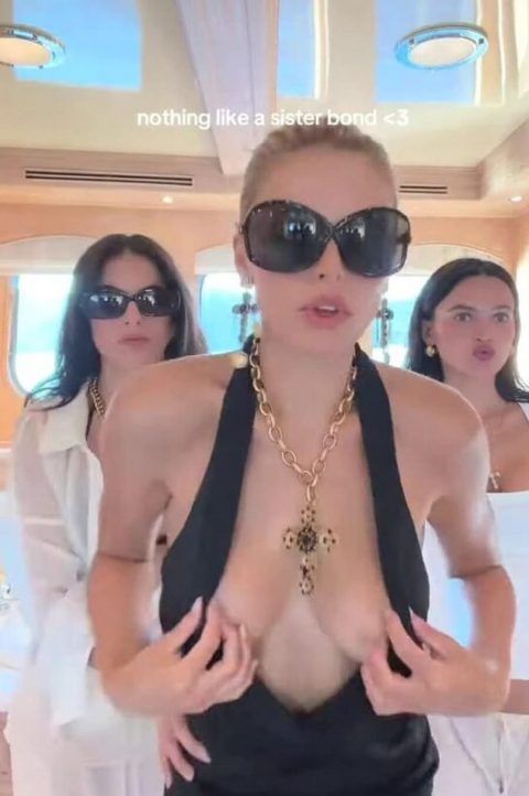 Celebrity Boob Slip – SI Model Black Dress Malfunction 8 Famous American model and television personality wearing an ultra-revealing plunging black dress and oversized dark sunglasses while dancing outdoors on a luxury yacht-pic 2