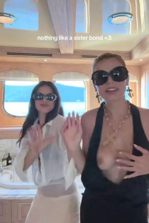 Celebrity Boob Slip – SI Model Black Dress Malfunction 10 Famous American model and television personality wearing an ultra-revealing plunging black dress and oversized dark sunglasses while dancing outdoors on a luxury yacht-pic 4