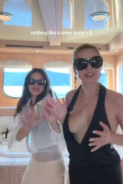 Celebrity Boob Slip – SI Model Black Dress Malfunction 11 Famous American model and television personality wearing an ultra-revealing plunging black dress and oversized dark sunglasses while dancing outdoors on a luxury yacht-pic 5