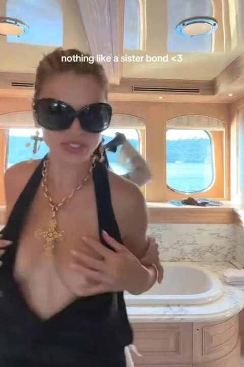 Celebrity Boob Slip – SI Model Black Dress Malfunction 12 Famous American model and television personality wearing an ultra-revealing plunging black dress and oversized dark sunglasses while dancing outdoors on a luxury yacht-pic 6