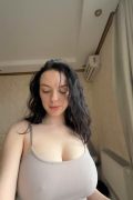 Busty brunette exposes big natural boobs from tight braless top in bedroom