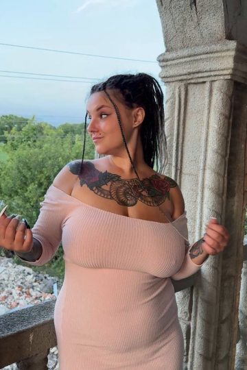 Chubby tattooed girl flashing large breasts